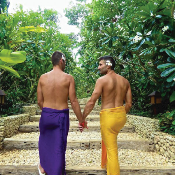 Gay couple walking in LGBT friendly hotel